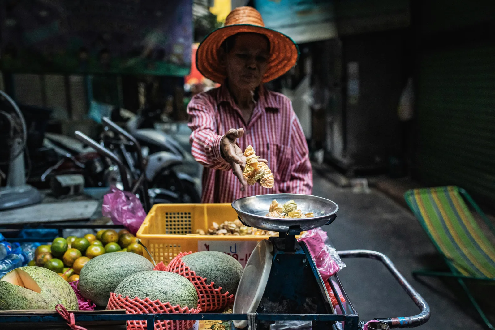 A local cook serving street food to a queue of Thai regulars in Phuket