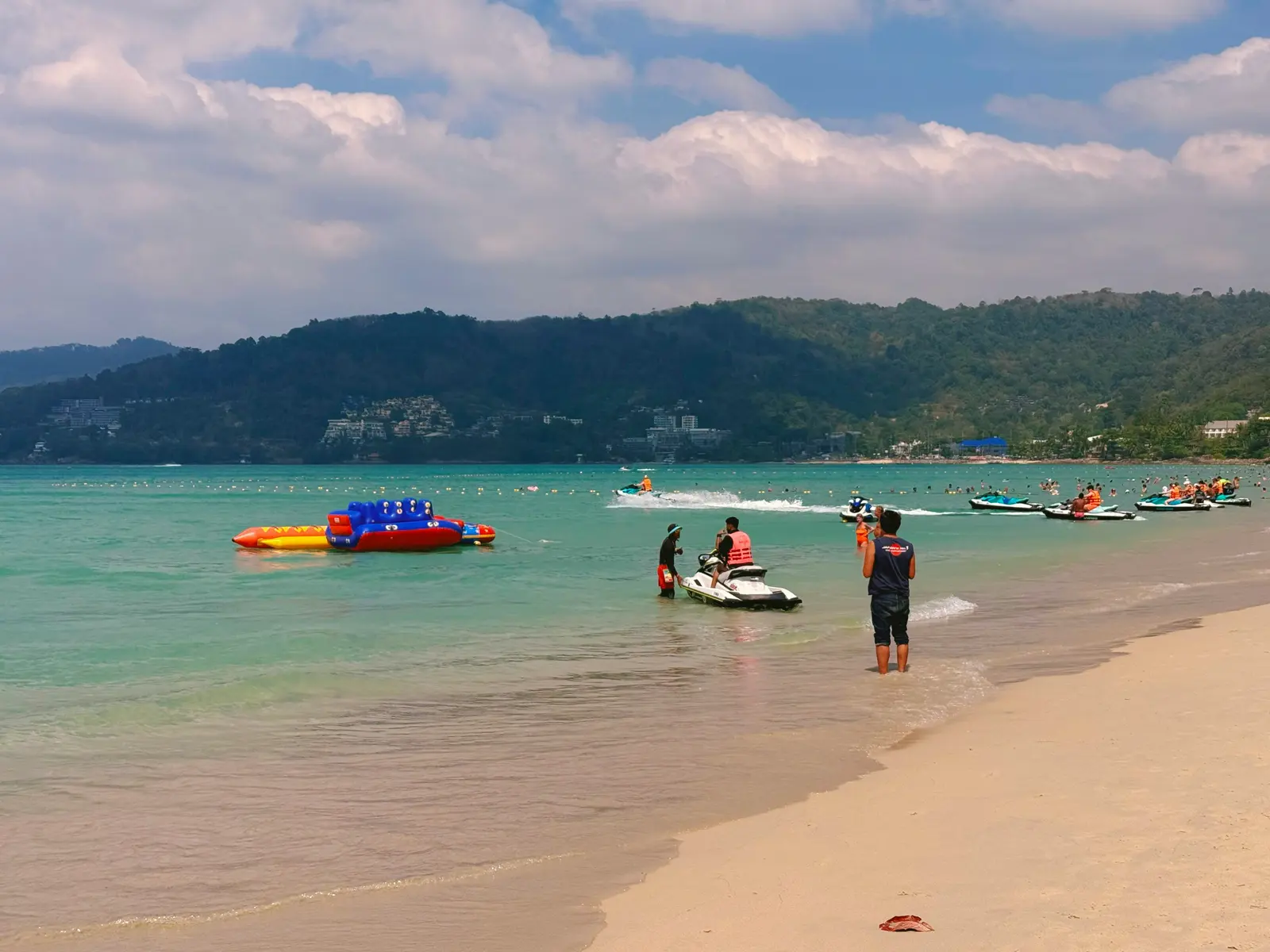 Family activities in Phuket: children snorkeling in calm turquoise water off a Phuket beach