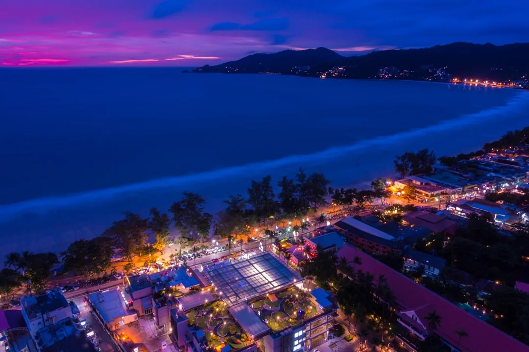 Phuket nightlife guide — neon-lit Bangla Road strip in Patong at night with crowds and beach clubs